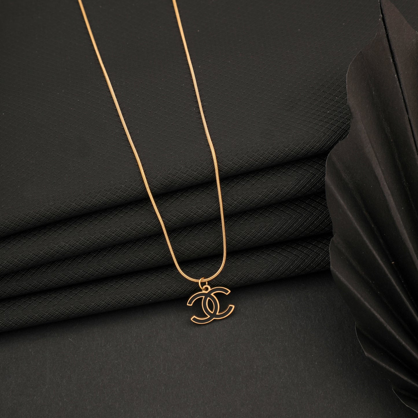 CROSS BLACK GOLD NECKLACE